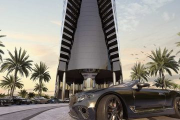 Bentley in front of skyscraper