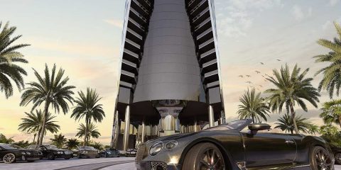 Bentley in front of skyscraper