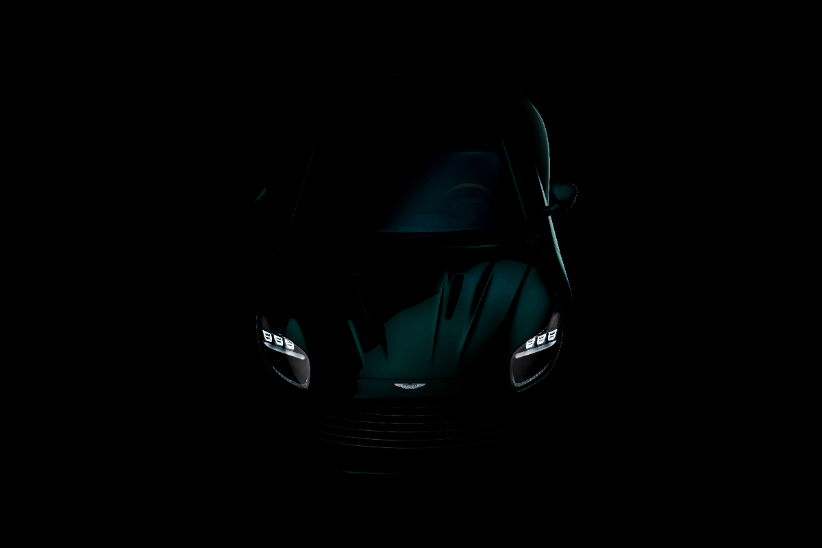 Aston Martin DB facing viewer shrouded in darkness