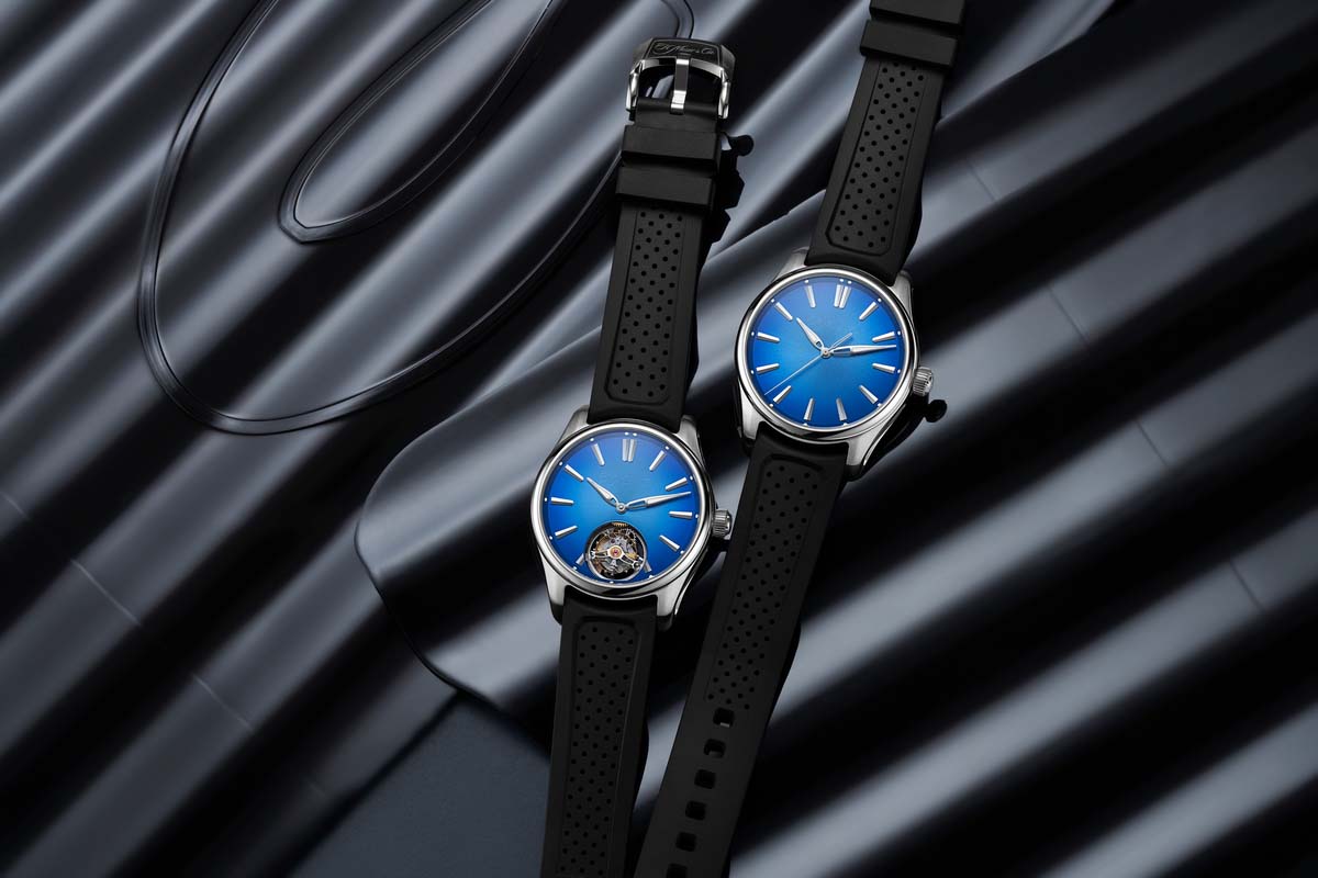 Two CIE brand blue watches on a black background. 