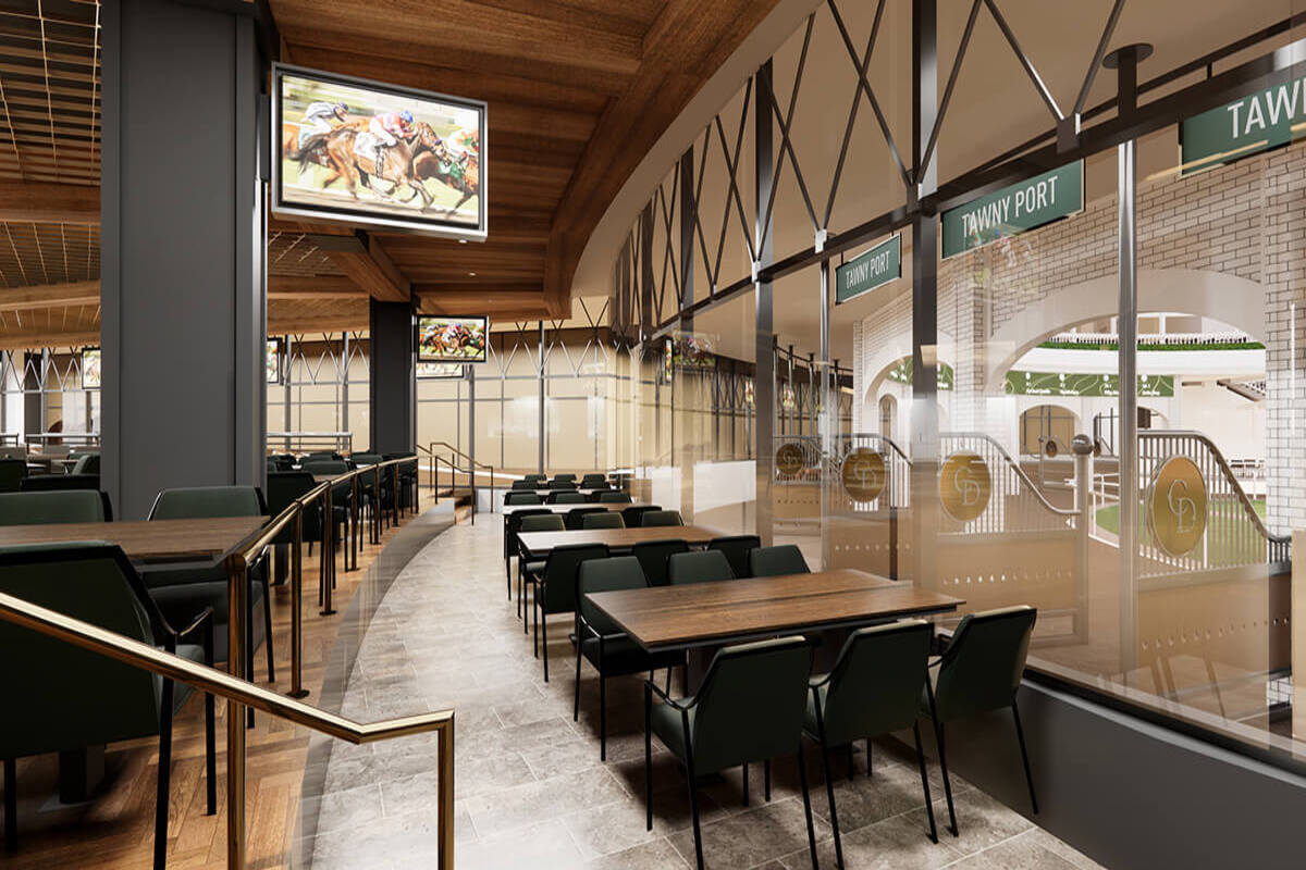 A restaurant/bar inside the Kentucky Derby stadium. A video of the race plays on a TV.