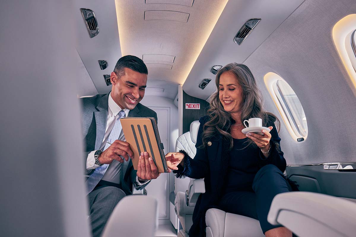 Two people experiencing the best of private aviation on the Aboard the Citation Ascend
