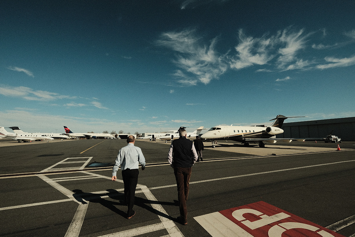 Pilot and investor approaching a taxi'd bombardier plane