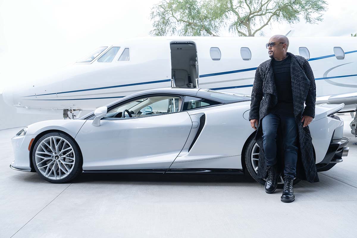 Daymond John in front of a lamborghini and 2002 CESSNA 560XL twinjet